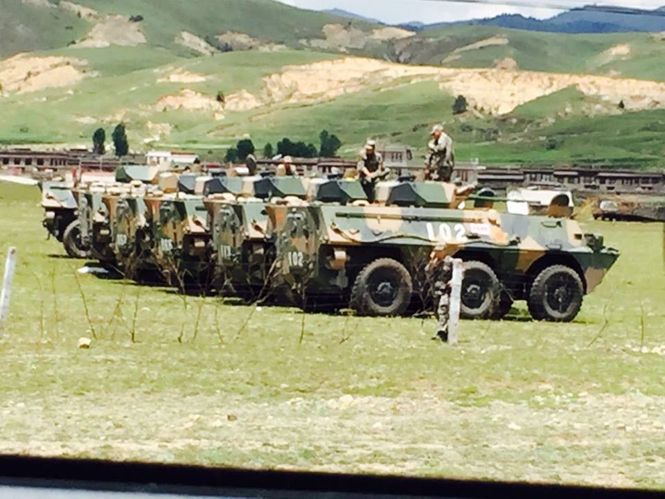 People's Armed Police force atop combat vehicles in Lithang